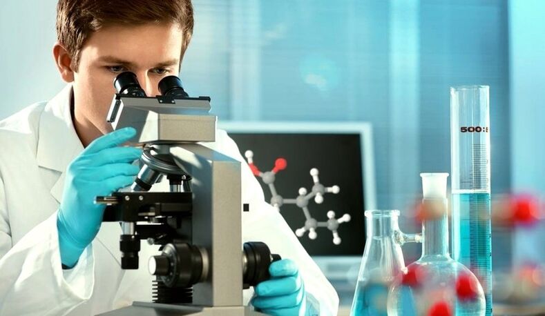 A specialist examines the material under the microscope